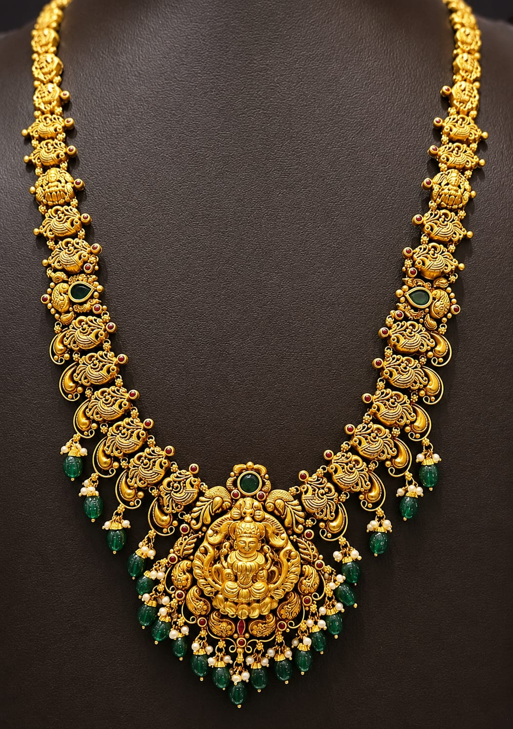 Bridal gold necklace and earring set displayed on a mannequin