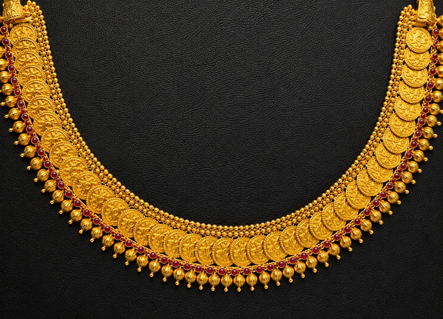 Jeweller's hands presenting a custom-designed ring and necklace